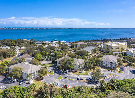 A view of a residential area with a large body of water in the background.