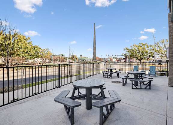 Outdoor patio with picnic tables at Aspire at Church St Affordable Apartments in Norfolk, VA