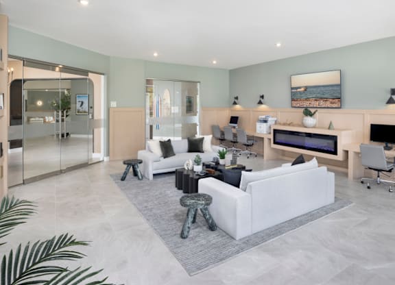 A modern living room with a white sofa and a television.