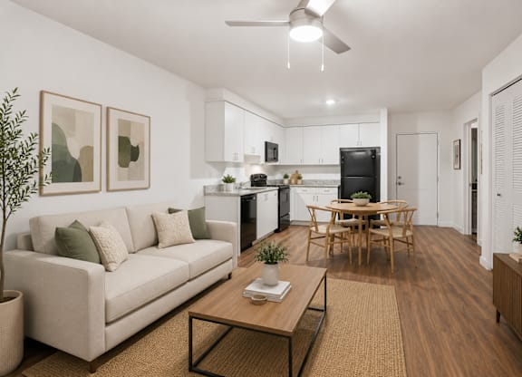 A living room with a couch, a coffee table, and a television.