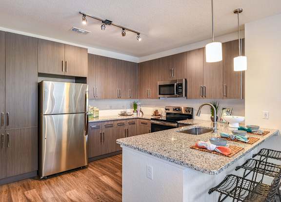 Kitchen with stainless steel appliances at The Exchange Luxury Apartments in St. Petersburg, FL