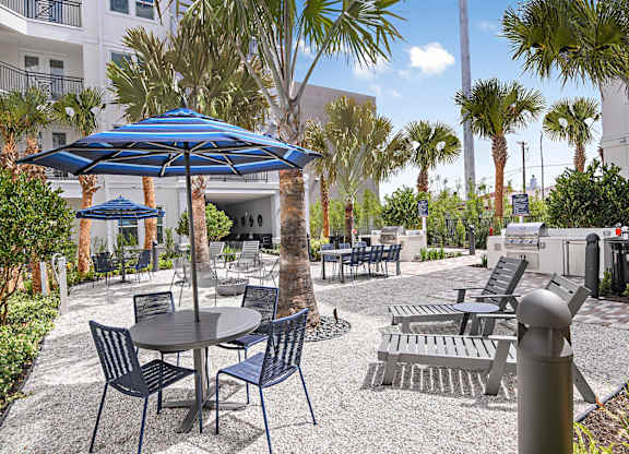 Outdoor courtyard with grills and seating at The Foundry Luxury Apartments in Tampa FL