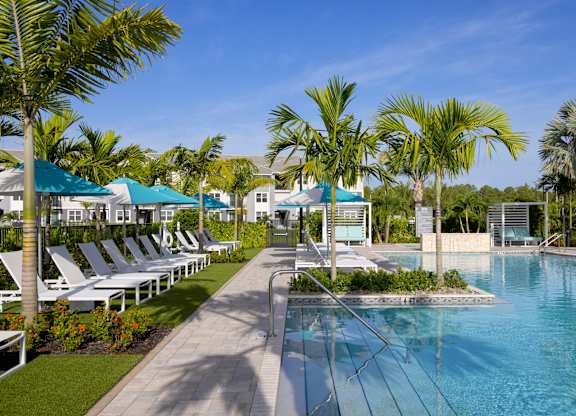 Heated Pool and Sun Loungers at Everly Apartments in Naples, FL
