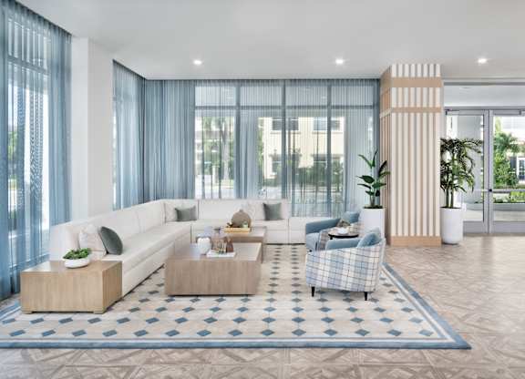 Grand clubhouse with lounge seating area at The Marc Apartments in Palm Beach Gardens FL