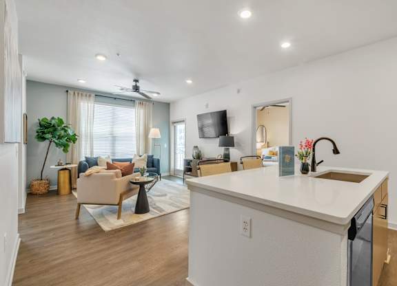 an open living room with a kitchen and a living room at Apex apartments in Colorado Springs, CO