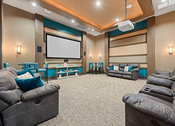 A home theater with a large screen and comfortable seating.