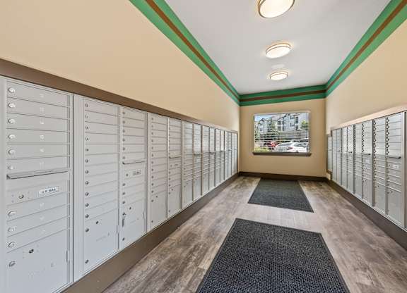A long hallway with mailboxes on both sides.