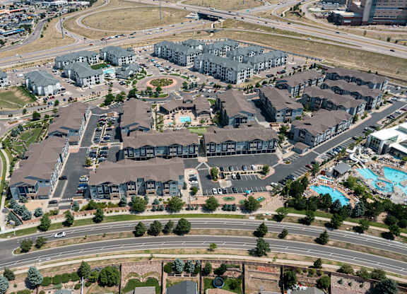 An aerial view of a residential area with houses and a swimming pool.