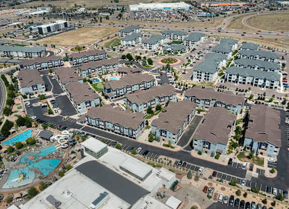 A bird's eye view of a residential complex with a swimming pool.