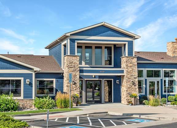 A blue building with a stone pillar in front.