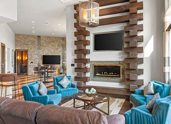 A modern living room with a fireplace and a television mounted above it.