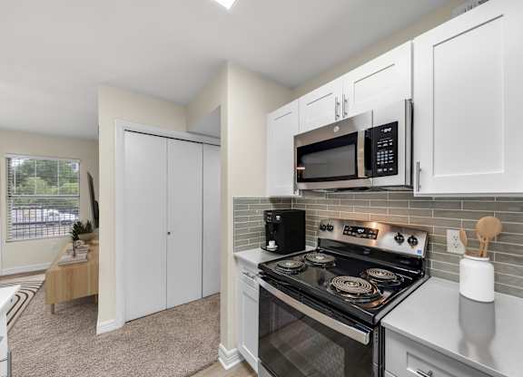 A kitchen with a stove top oven and microwave.