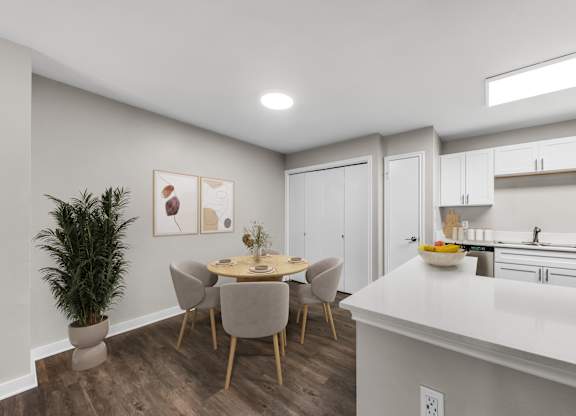 A modern kitchen with a dining table and chairs.