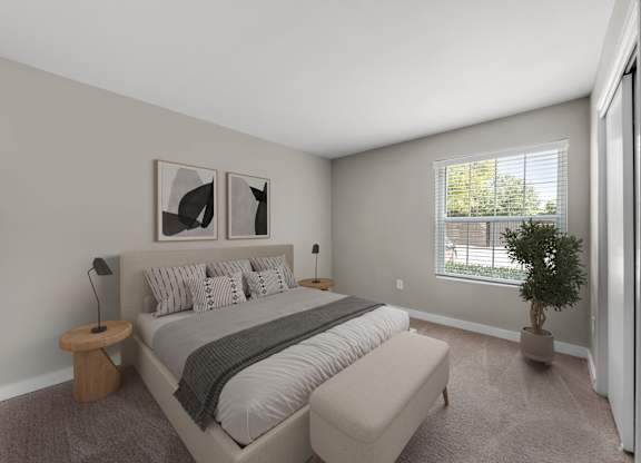 A bedroom with a large bed and two pictures on the wall.