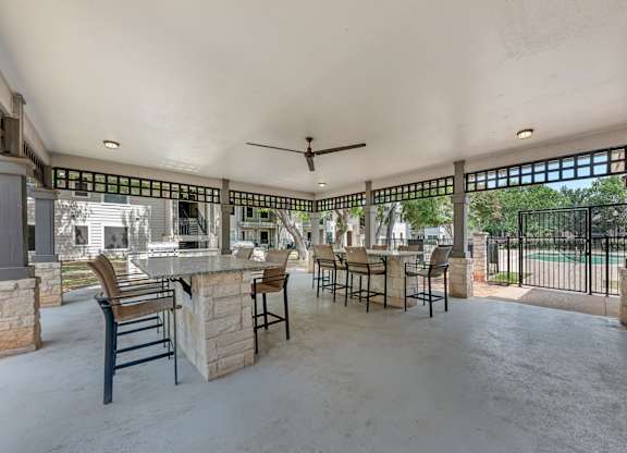 A patio with a bar and chairs is shown.