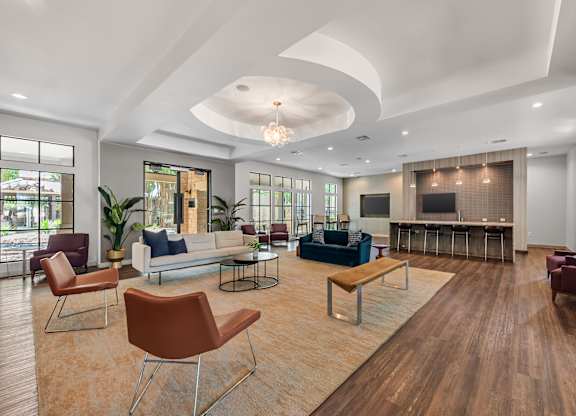 A living room with a white ceiling and wooden floors.
