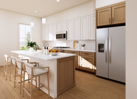 a kitchen with a center island and a stainless steel refrigerator