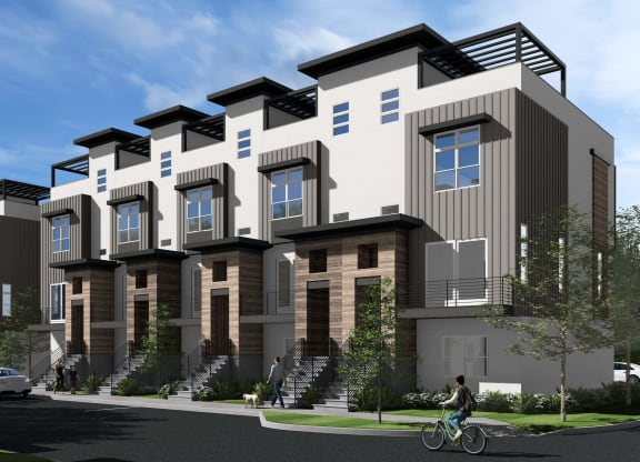 a rendering of a row of apartment buildings with a person riding a bike