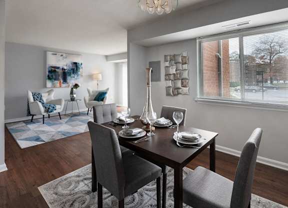 a dining room with a table and chairs at The Glendale Residence, Lanham, MD