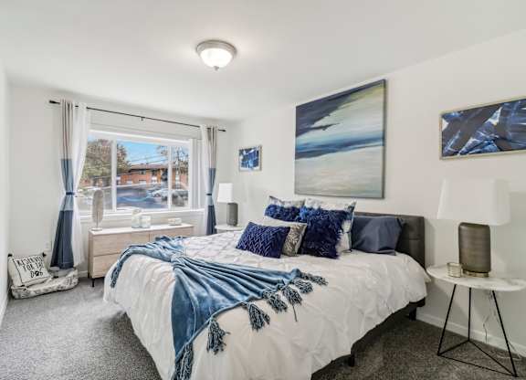 a bedroom with a bed and a large window at Oaks at Oxon Hill, Oxon Hill, Maryland
