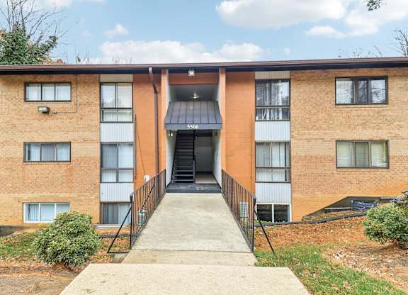 the front entrance of a brick apartment building at Oaks at Oxon Hill, Oxon Hill, Maryland