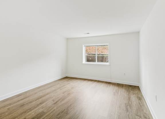 an empty room with white walls and a window at Oaks at Oxon Hill, Oxon Hill, Maryland