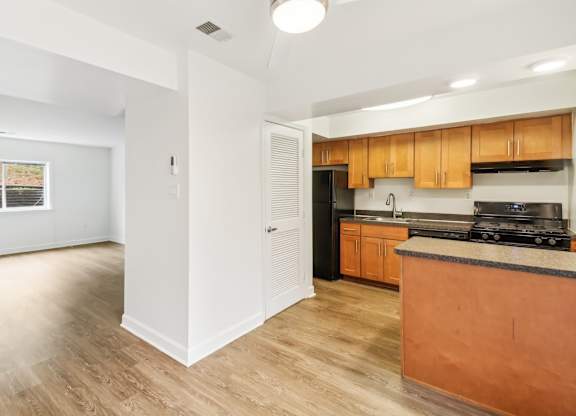 a kitchen with a counter top and a wall with different shapes on it at Oaks at Oxon Hill, Oxon Hill, Maryland
