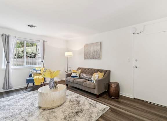 a living room with a couch and a round coffee table at Oaks at Oxon Hill, Oxon Hill, Maryland
