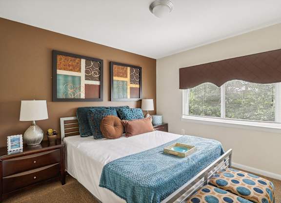a bedroom with a bed and a window at Andrews Ridge Apartments, Suitland, MD