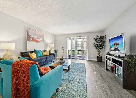 A living room with a blue couch and a television.