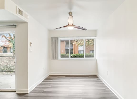 an empty room with a window and a ceiling fan at Oaks at Oxon Hill, Oxon Hill, Maryland
