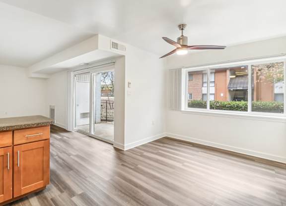 a living room with a ceiling fan and a door to a patio at Oaks at Oxon Hill, Oxon Hill, Maryland