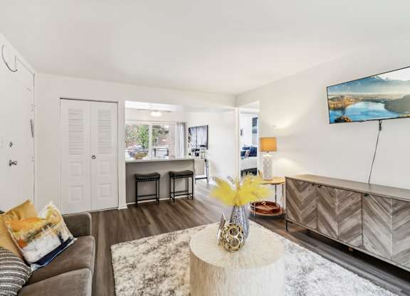 a living room with a couch and a table at Oaks at Oxon Hill, Oxon Hill, Maryland
