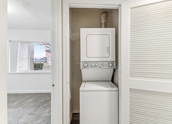a laundry room with a washer and dryer and a window at Oaks at Oxon Hill, Oxon Hill, Maryland