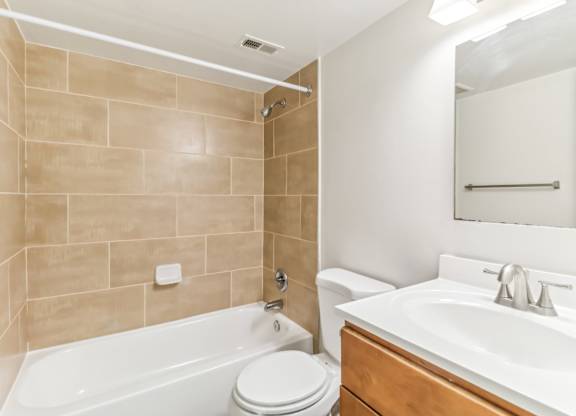 a bathroom with a sink toilet and bath tub at Oaks at Oxon Hill, Oxon Hill, Maryland