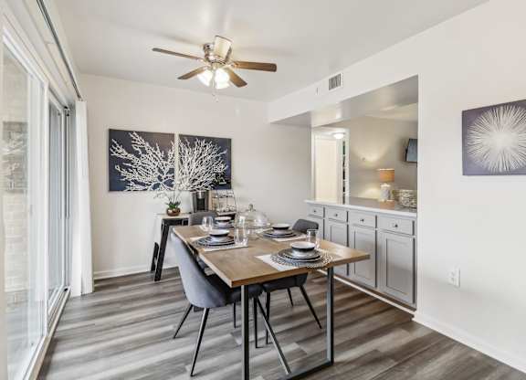 a dining room with a table and a ceiling fan at Oaks at Oxon Hill, Oxon Hill, Maryland