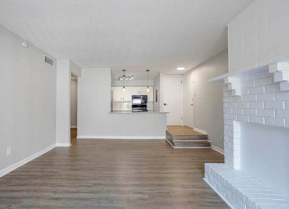 A modern living room with a fireplace and a flat screen TV at The Onyx Hoover Apartments, Hoover, Alabama