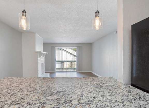 A bedroom with a large bed and a window with blinds at The Onyx Hoover Apartments, Alabama