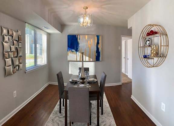 a dining room with a table and chairs at The Glendale Residence, Lanham, 20706