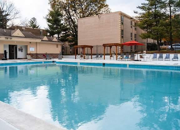 a swimming pool with a building in the background at The Glendale Residence, Lanham
