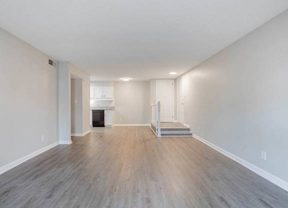 A spacious room with wood flooring and a fireplace at The Onyx Hoover Apartments, Hoover, AL, 35216