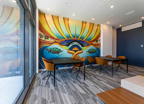 A conference room with a large mural on the wall.