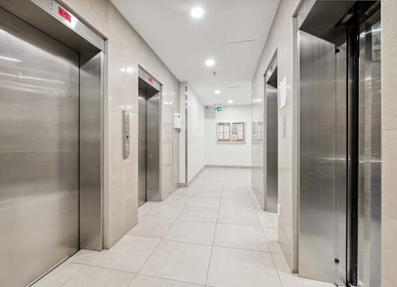 a row of elevators in a hallway of a building