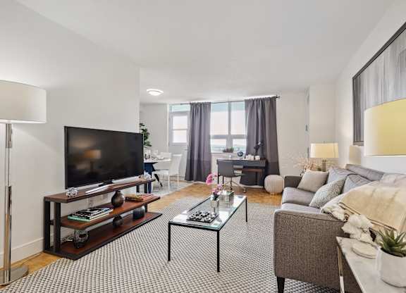 a living room with a couch and a coffee table and a television
