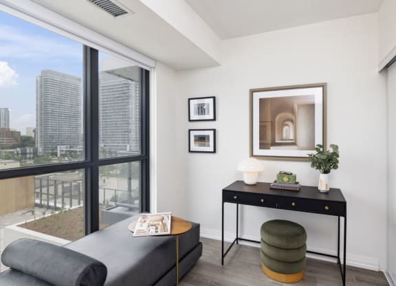 a living room with a couch and a table and a window