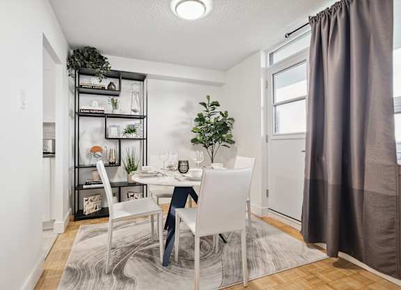 an image of a dining room with a table and chairs