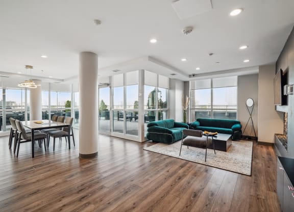 a living room with a green couch and a dining room table