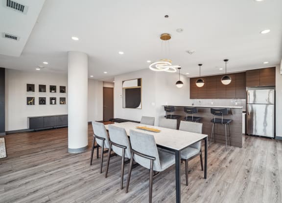 a kitchen and dining room with a white table and chairs