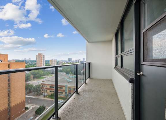 a balcony with a view of the city in the distance and a clear blue sky