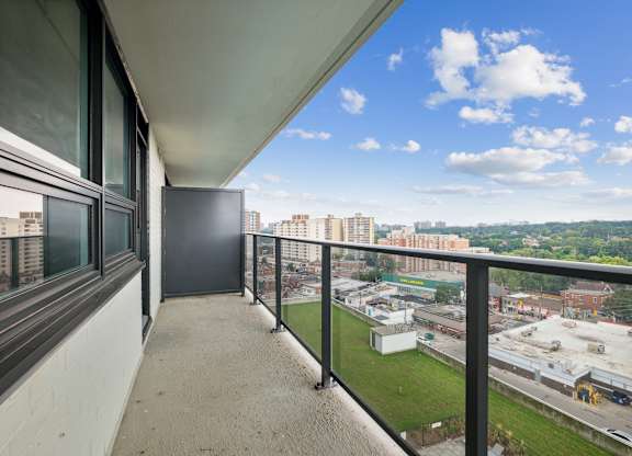 a balcony with a view of a city and a clear blue sky